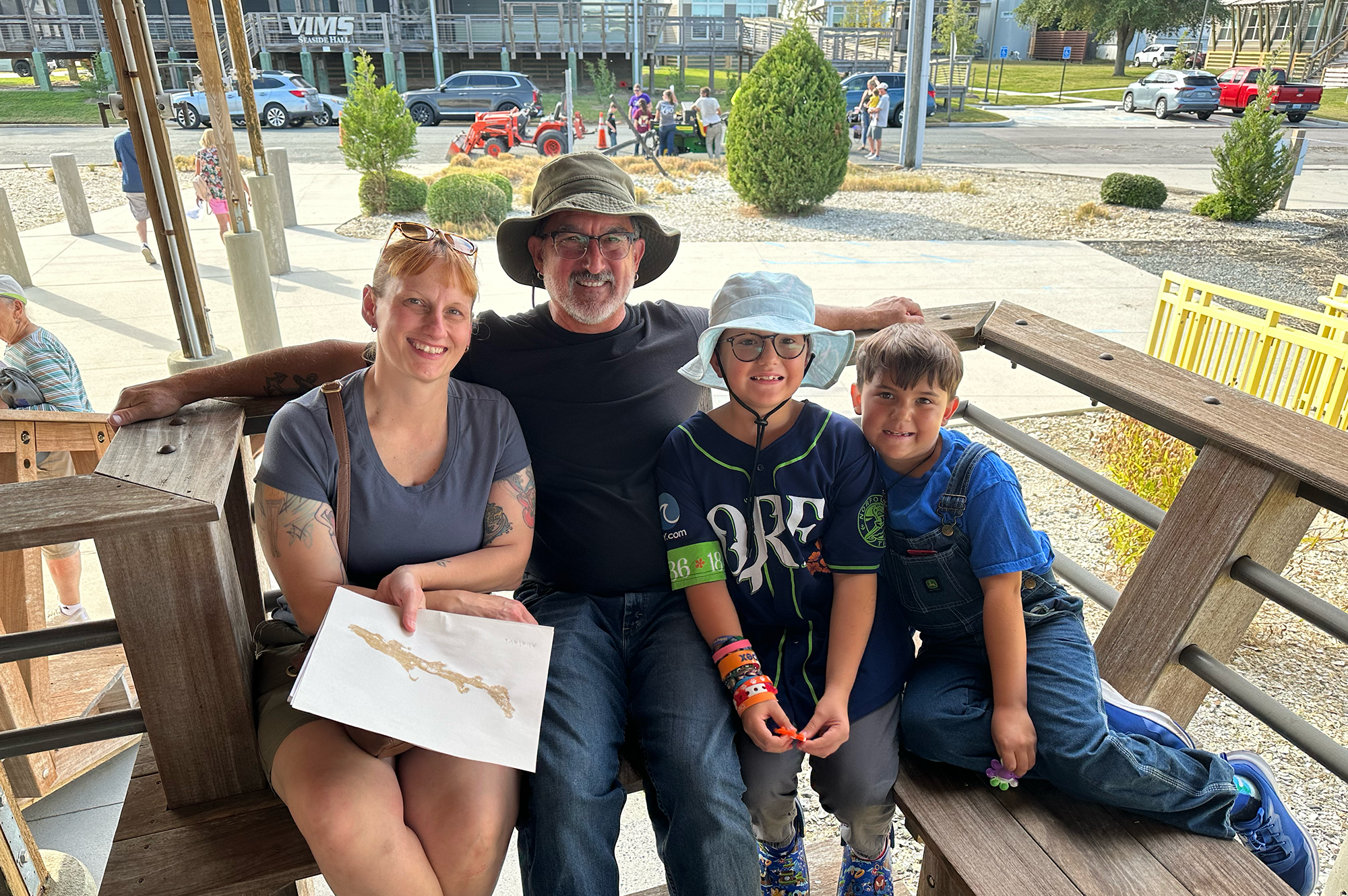 "Our kids’ favorite parts were the dissection and tagging the shark. And I liked the microscopes," said Tito Romero, pictured here with his wife, Jess, and their two children. Photo credit: Ethan Smith